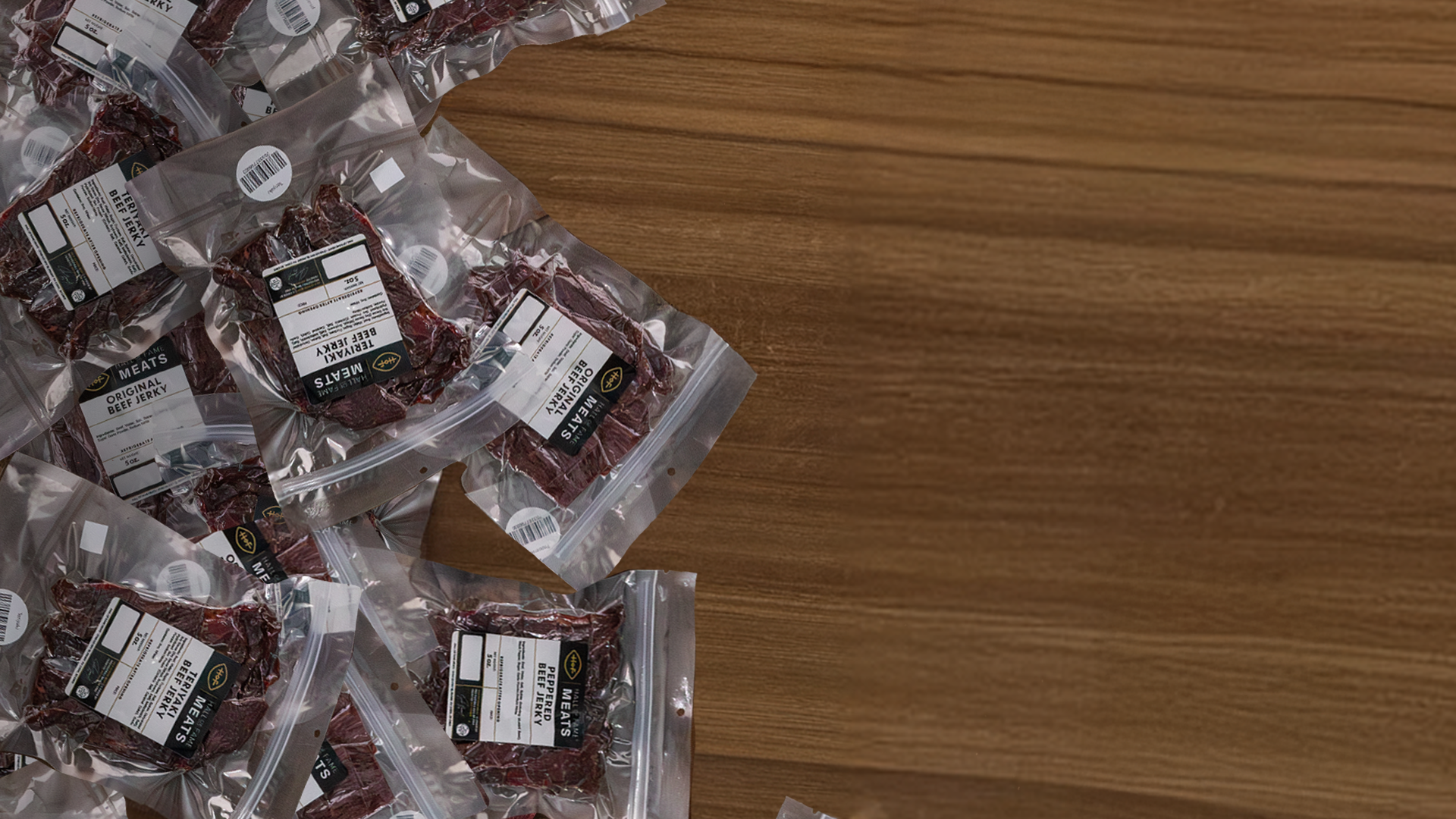 Beef Jerky packages with labels on a wooden surface